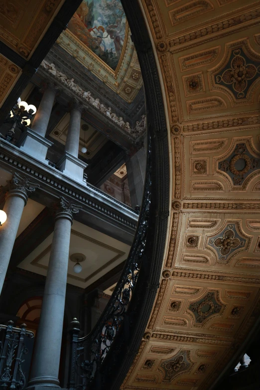 an ornate building with elaborate painted ceiling and large columns