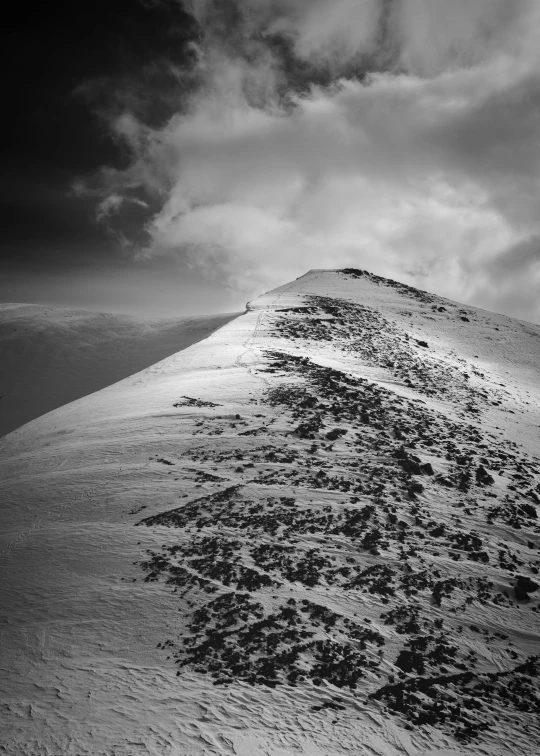 black and white pograph of a snowy hill