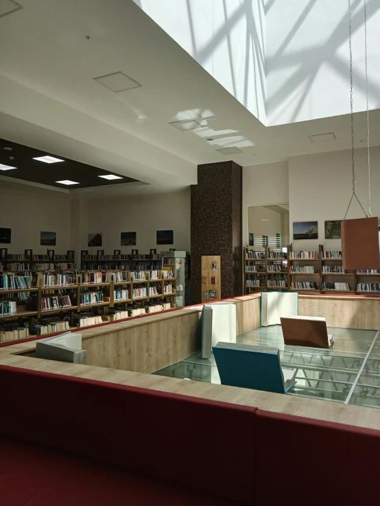 a liry full of books and sitting tables