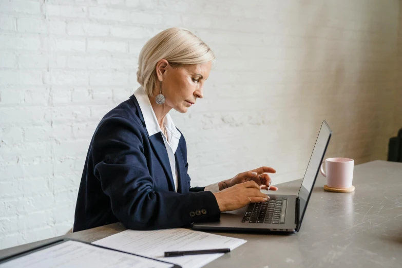 woman sitting at the table on her laptop