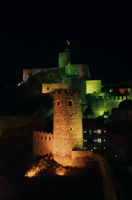 a very large castle like building lit up at night