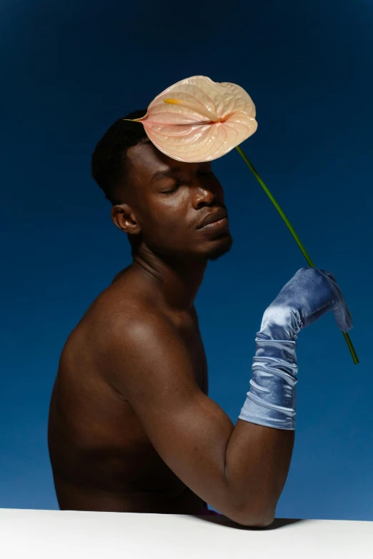 a man holding a flower on his head