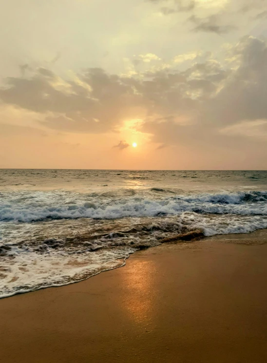 a very pretty sunset with some ocean waves