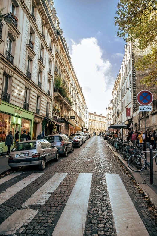 a street filled with cars driving down the middle of a street