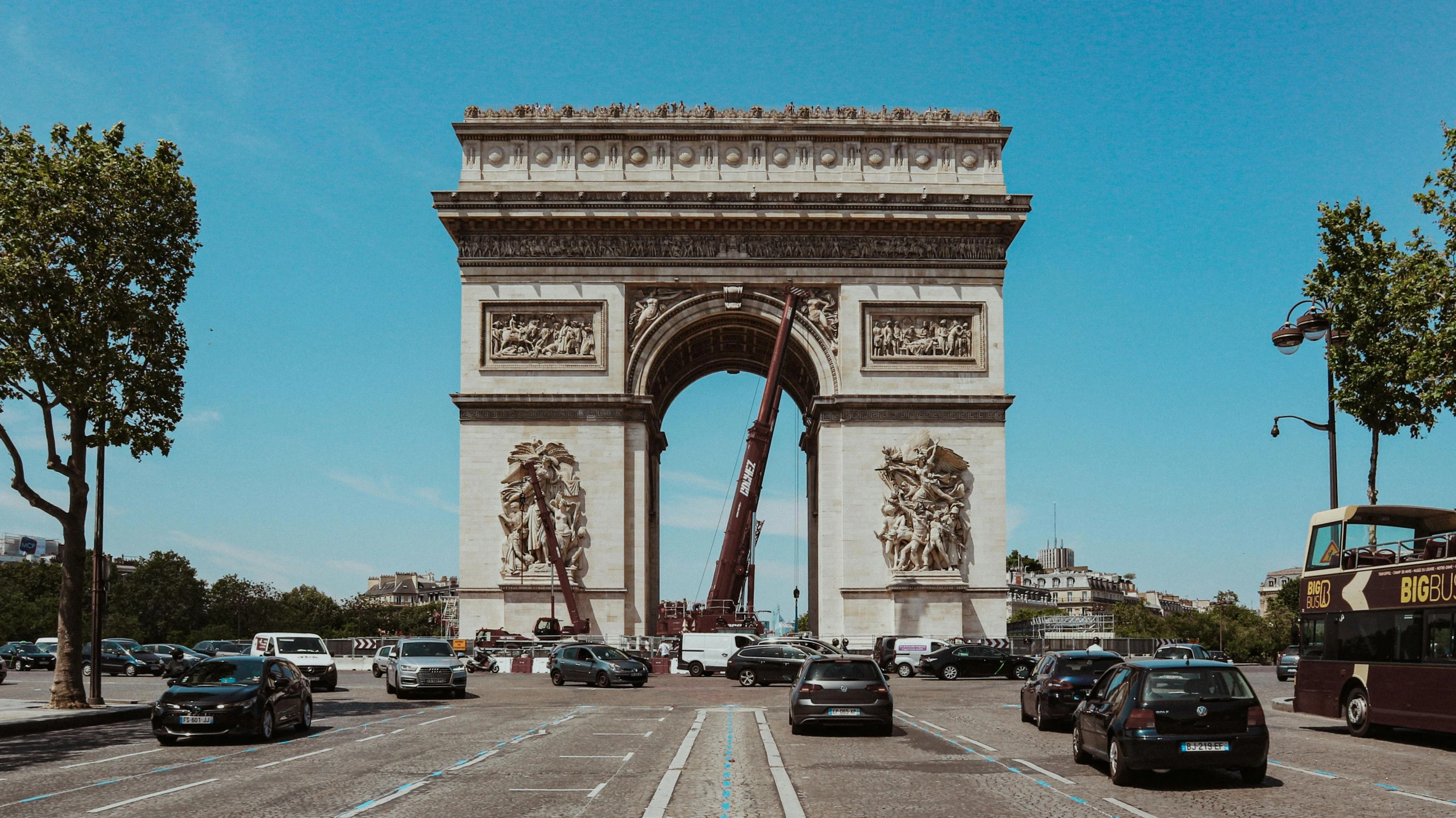 cars on the street in front of a monument