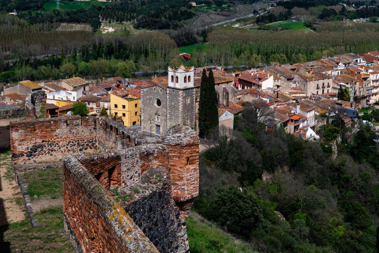 the castle is next to a valley and village