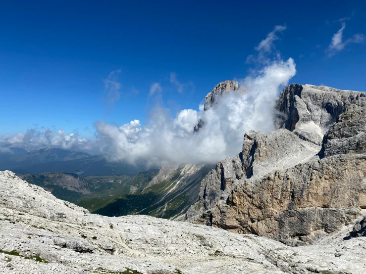 clouds cover mountains in the distance in a mountain