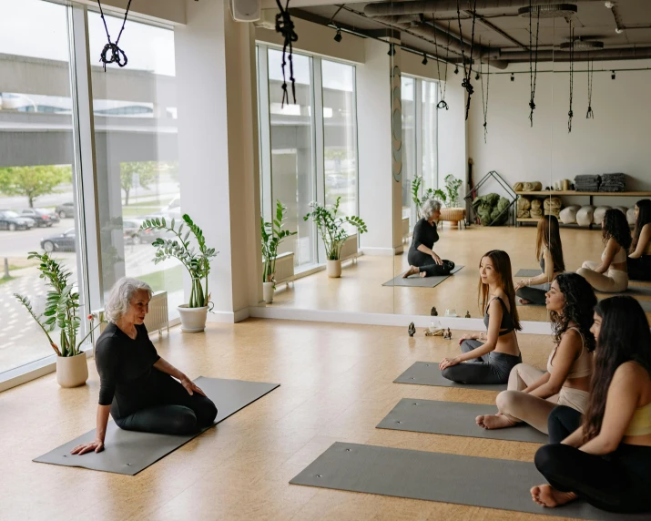 a group of people in a room doing yoga