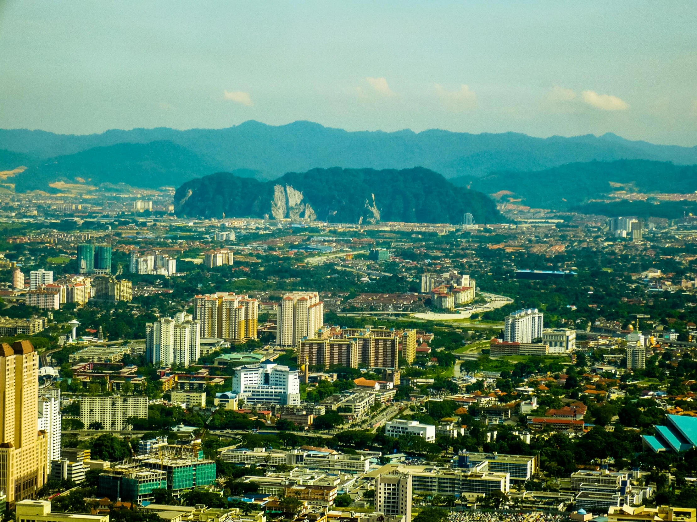 an aerial view of the city with mountains in the background