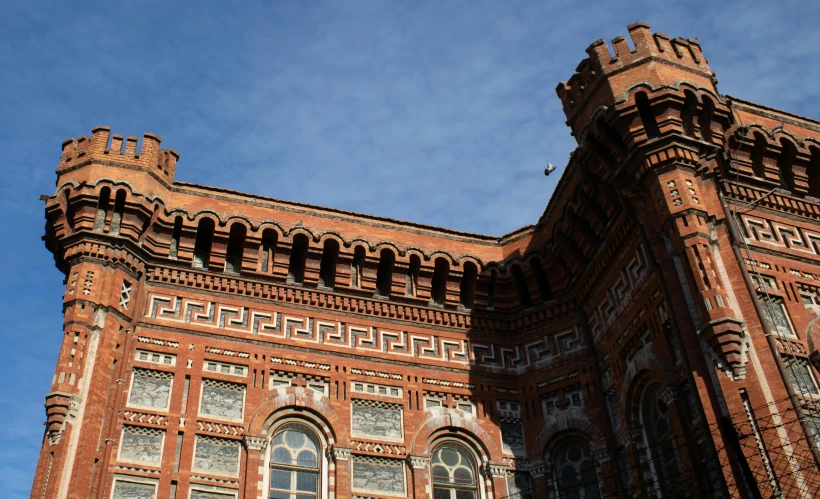 large building with two windows and many columns