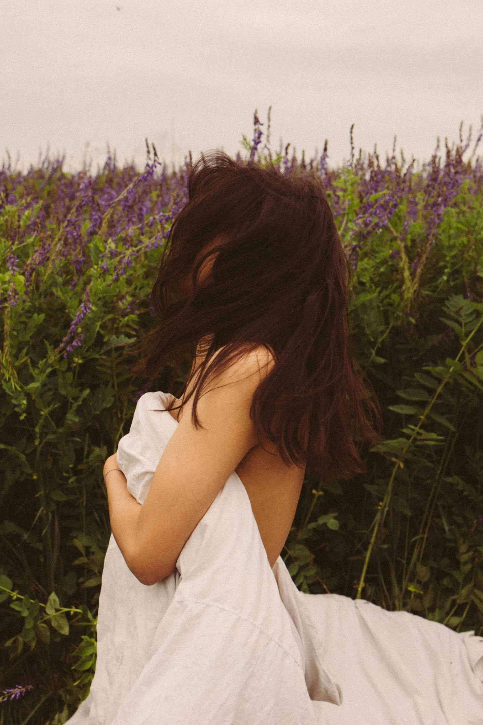 a woman in white is lying on the ground