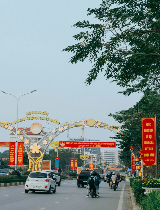 a number of vehicles near many banners and signs