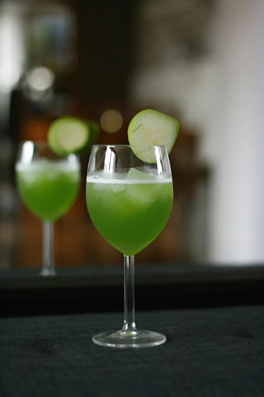 a close up of two glasses filled with different types of drinks