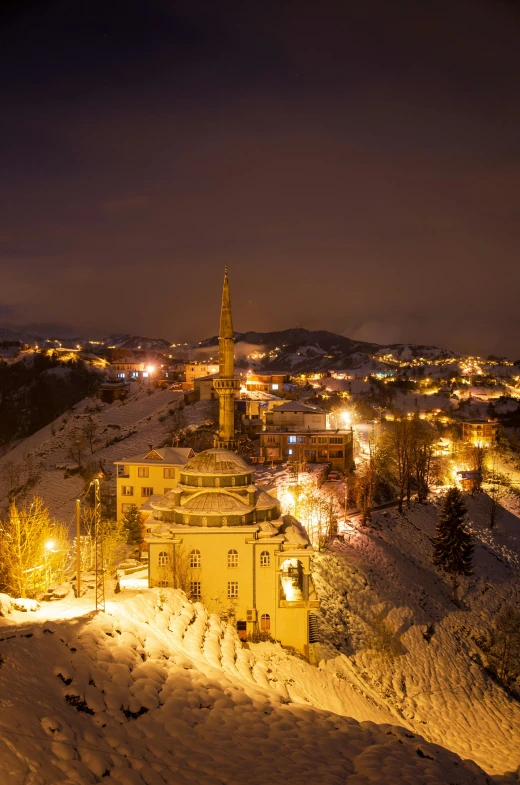 a town with snow covered ground next to buildings