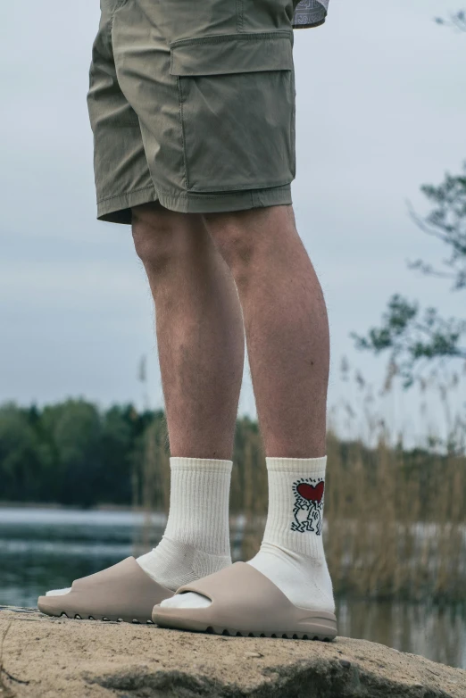 the legs of a person in khaki shorts and socks