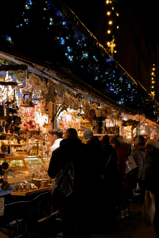 an indoor market with lots of people milling about it