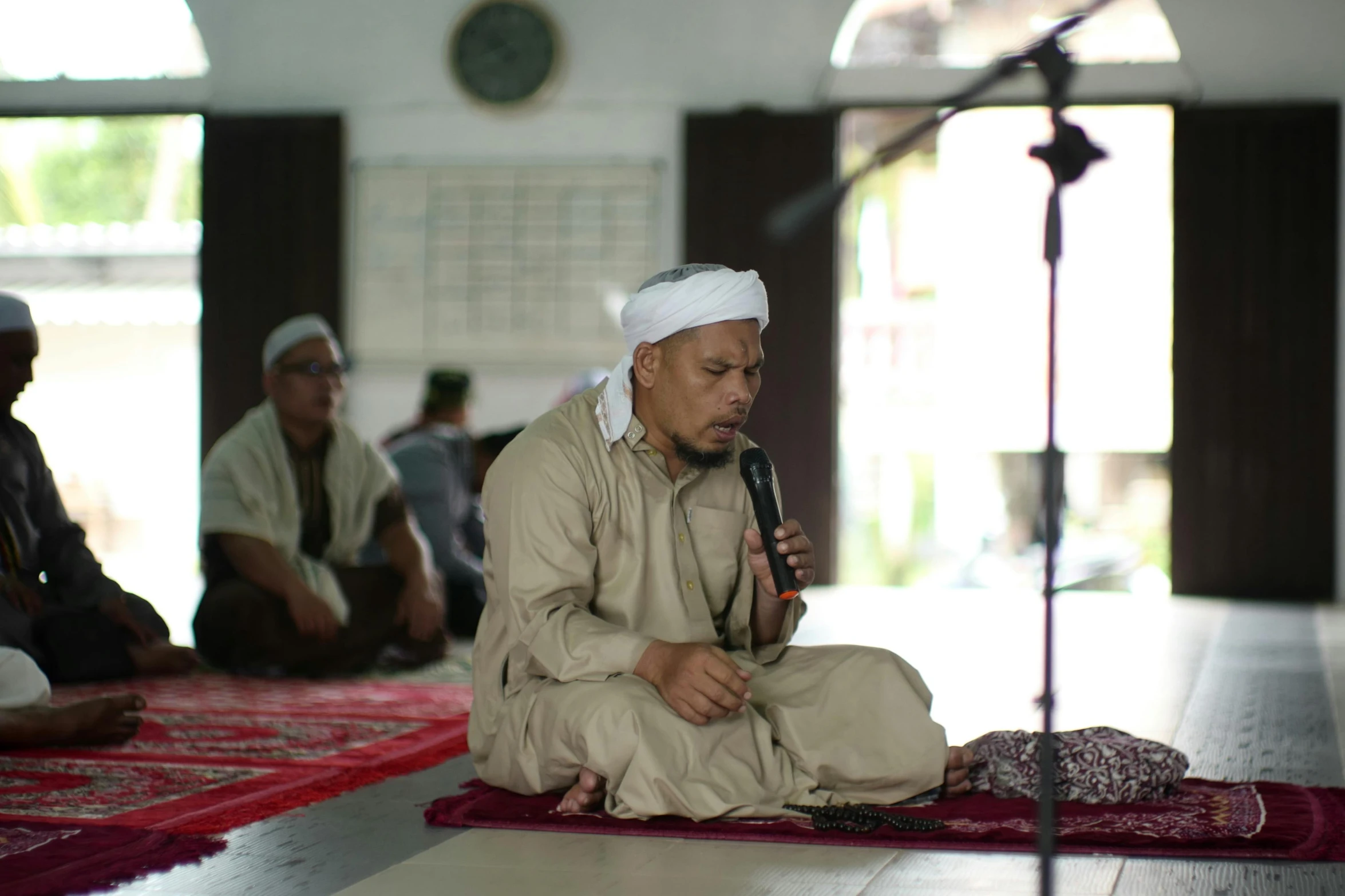 men doing religious practice together on their rugs