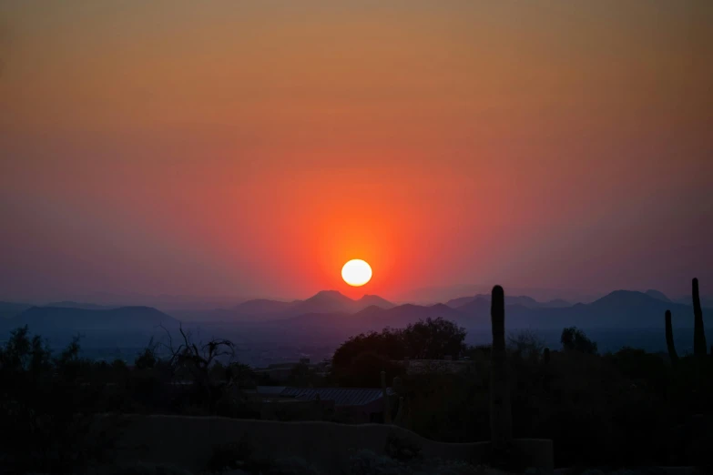 the sun rising over the mountains in arizona