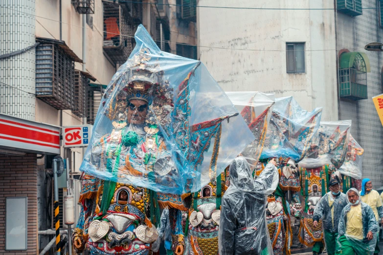 a group of people standing around each other in front of tents