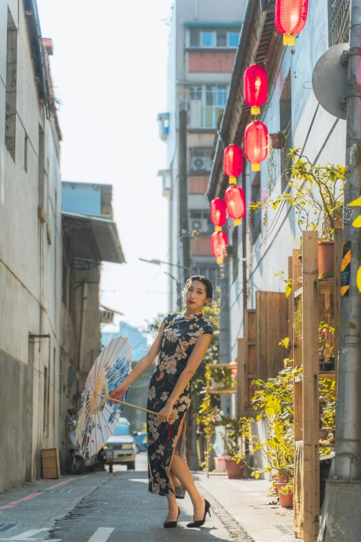 a woman with a umbrella walking down the street