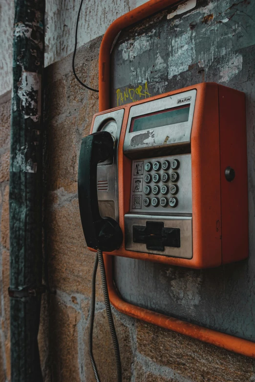 a close up of an old phone on the wall