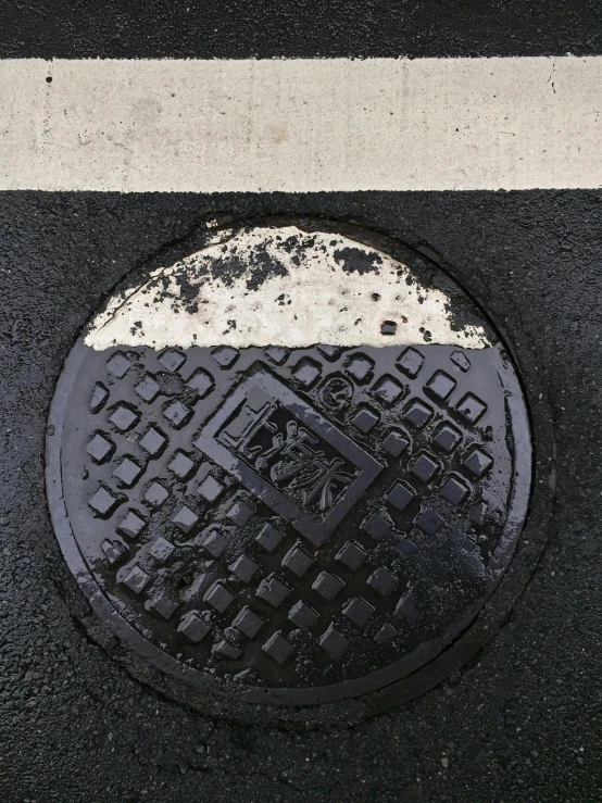 a manhole cover is seen in the ground