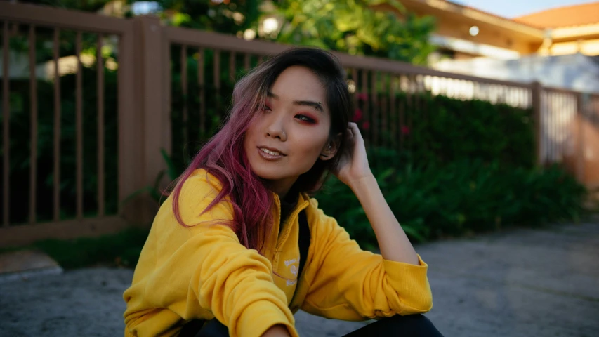 a girl with red hair sitting on the ground