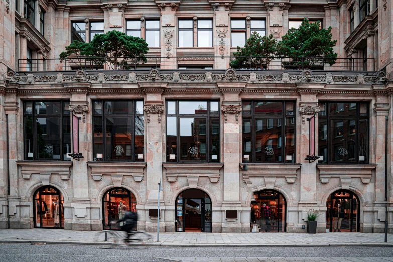 this old building has many windows, and one person is walking outside