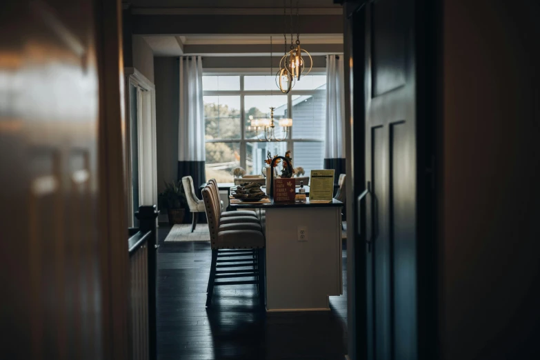 the view of a well - lit living room with chairs and a coffee table