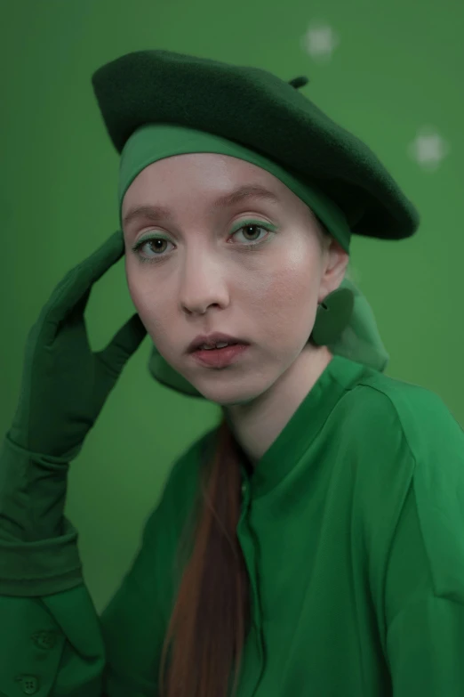 a  wearing a green outfit and beret