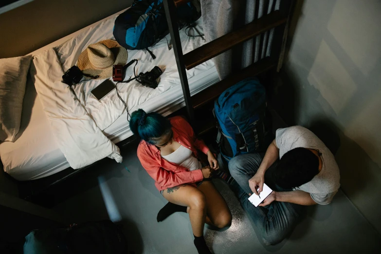 two people are sitting near each other on a bunk bed