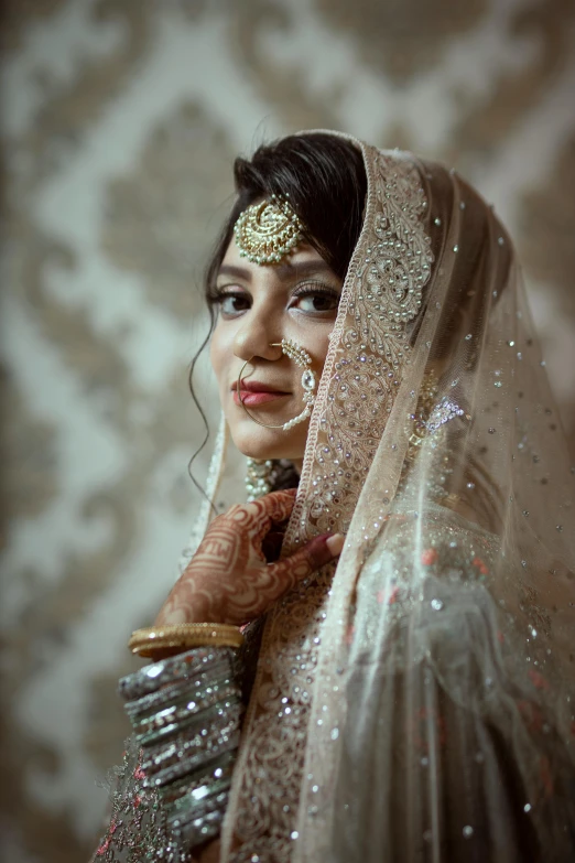 woman wearing heavy gold jewelry under a veil