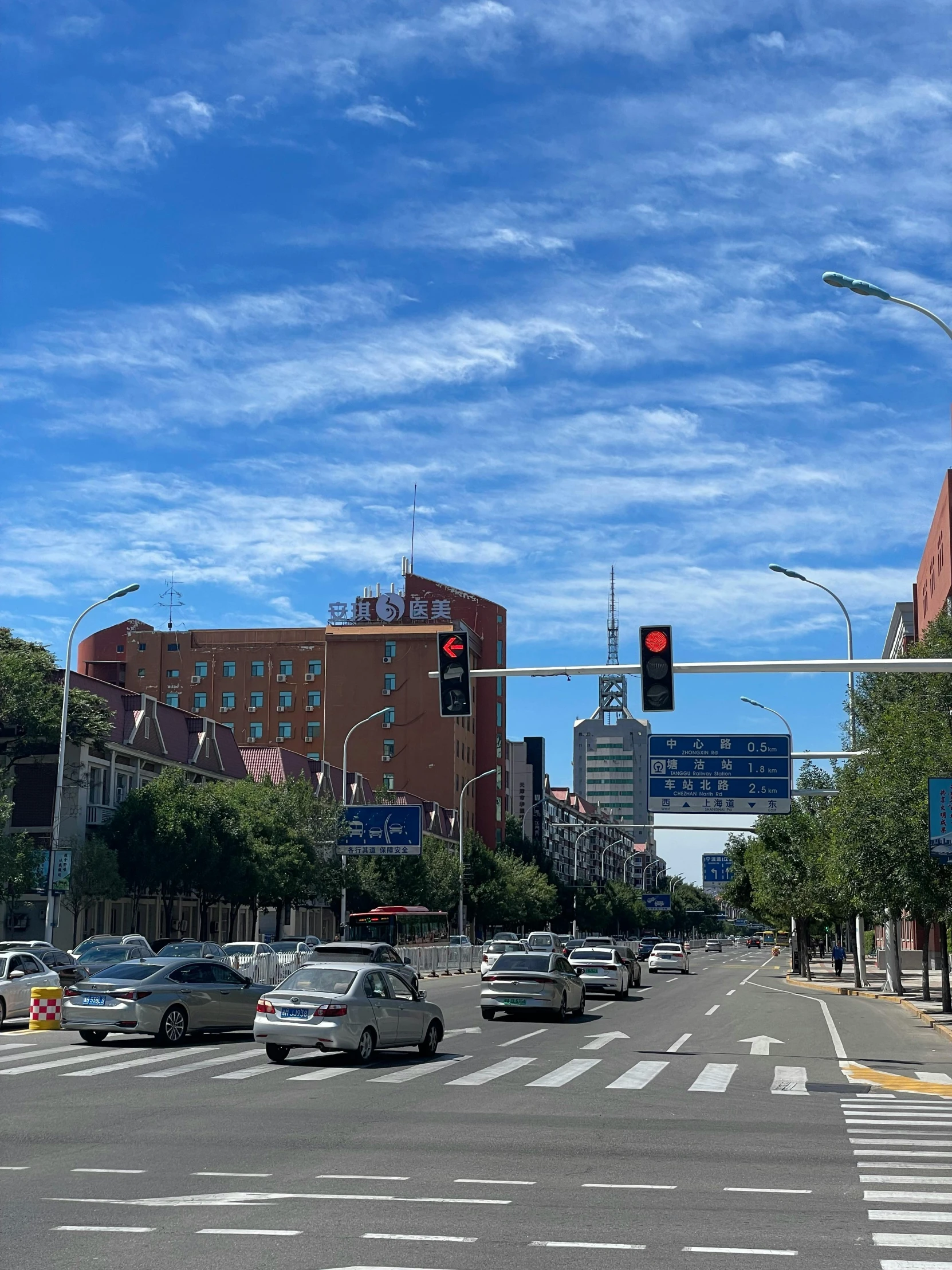 a street corner with cars driving on it and buildings around