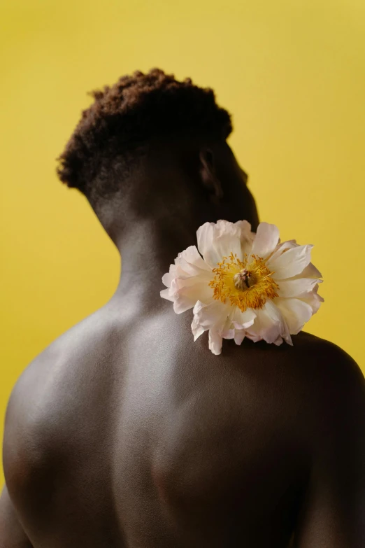 a man with a white flower on his back