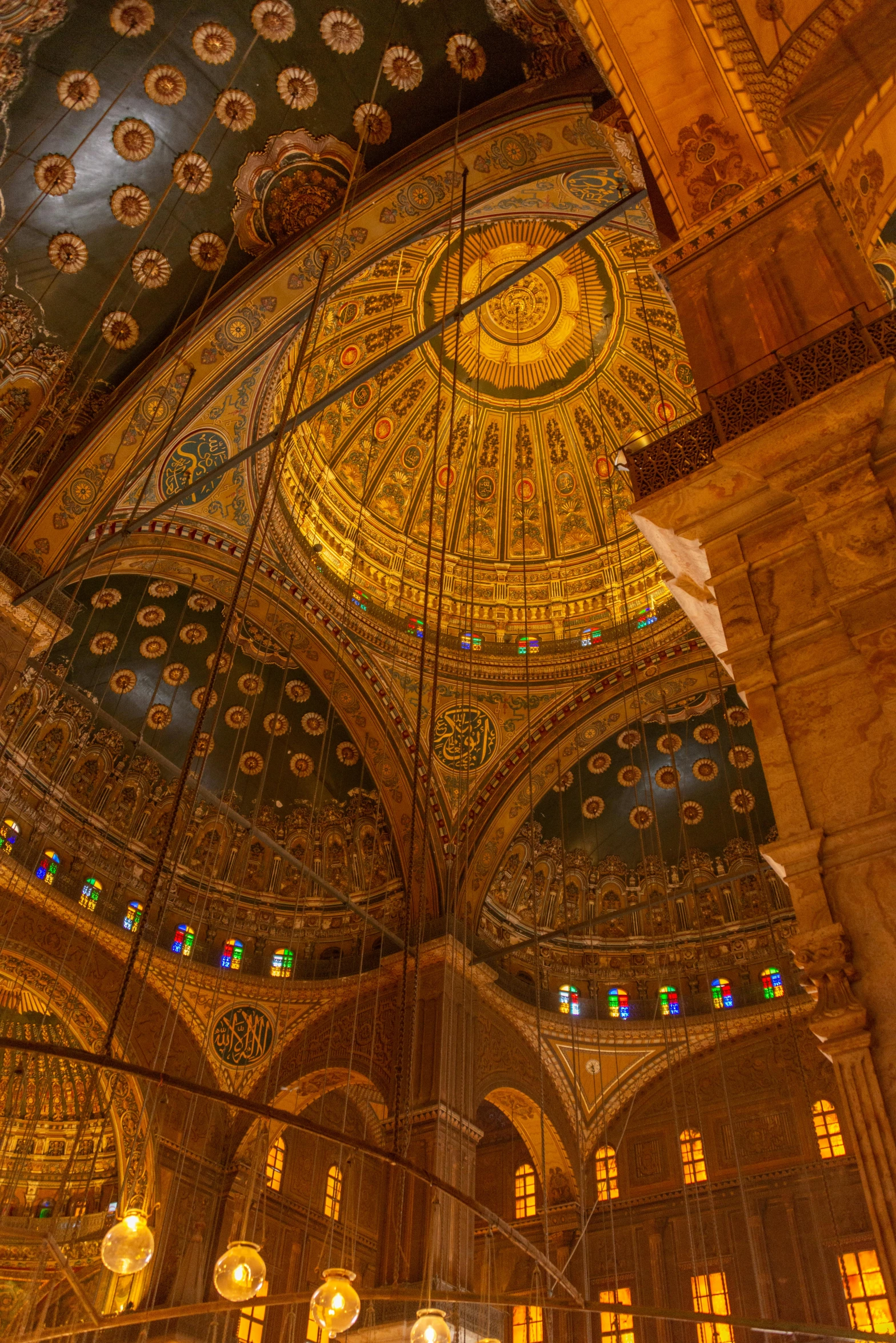 a dome like ceiling inside a building with stained glass windows