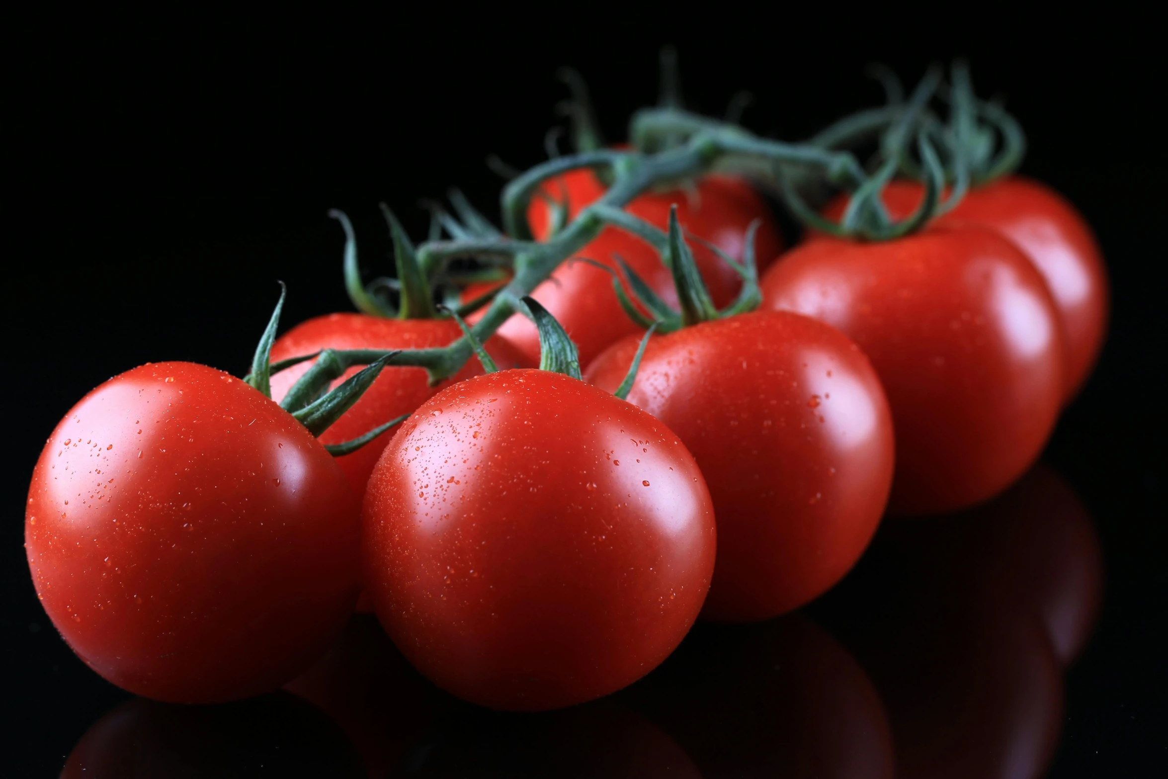 several tomatoes sitting next to each other on a table