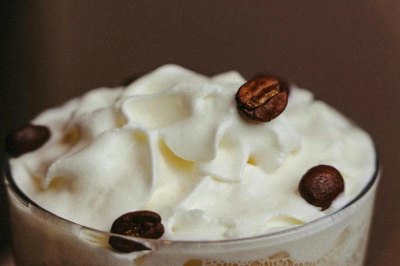 an alcoholic beverage with whipped cream and nuts