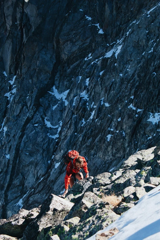 a mountain goat climbs along the side of the mountain