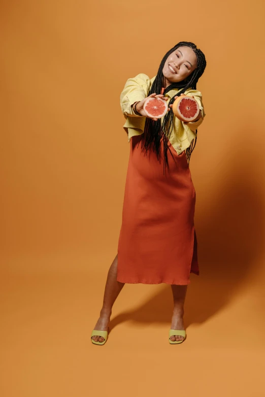 woman posing with two halves of watermelon