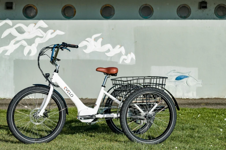 a bicycle parked outside of a building on the grass