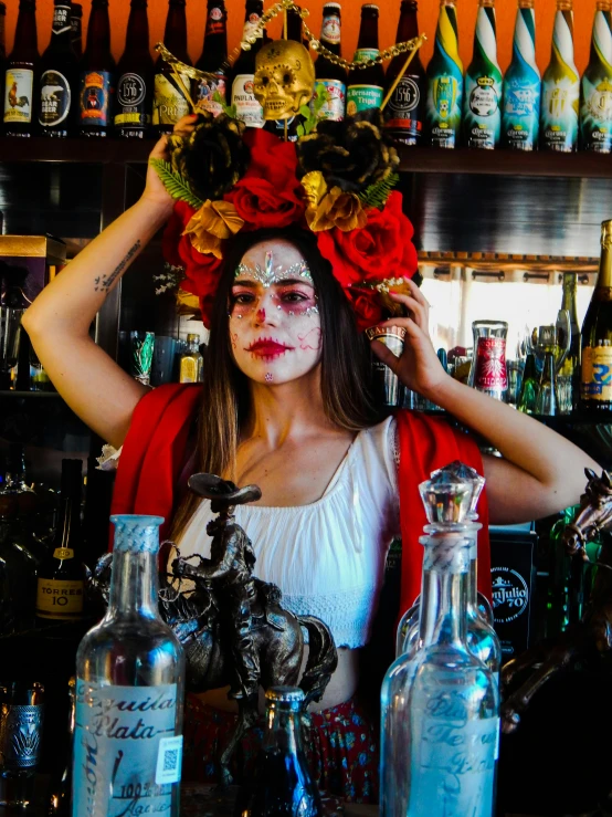 woman dressed in white with decorations on head standing at bar