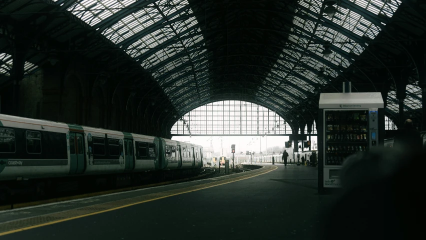 a train station with a train pulled up to the platform