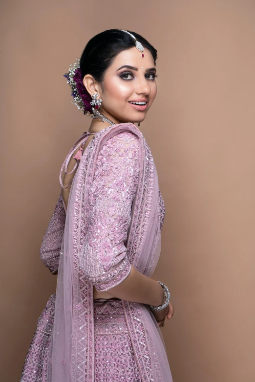 a woman wearing a purple outfit with a floral head piece