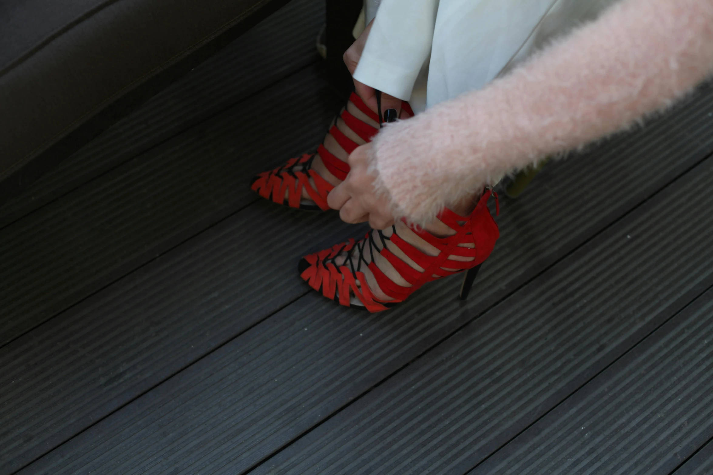 woman in a white dress with red high heel shoes