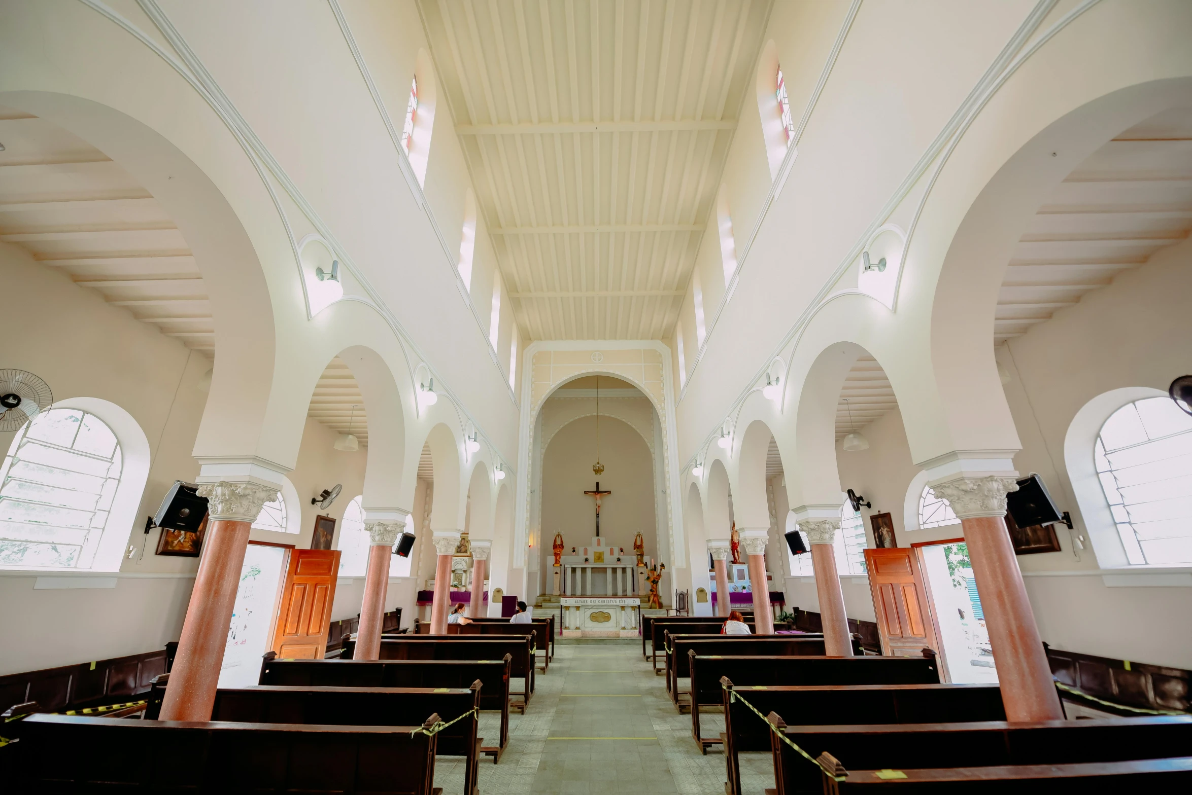 empty rows of pews in a church during the day