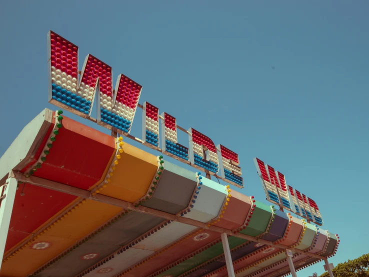 a colorful carnival ride with red and blue banners