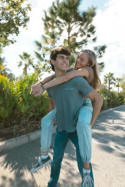 the young man has his arm around the woman on the skateboard