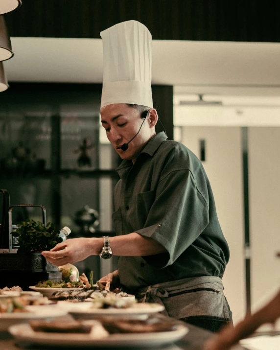 a man wearing a chef's hat making food in a kitchen