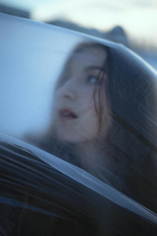 a blurry picture of a girl's face through a window