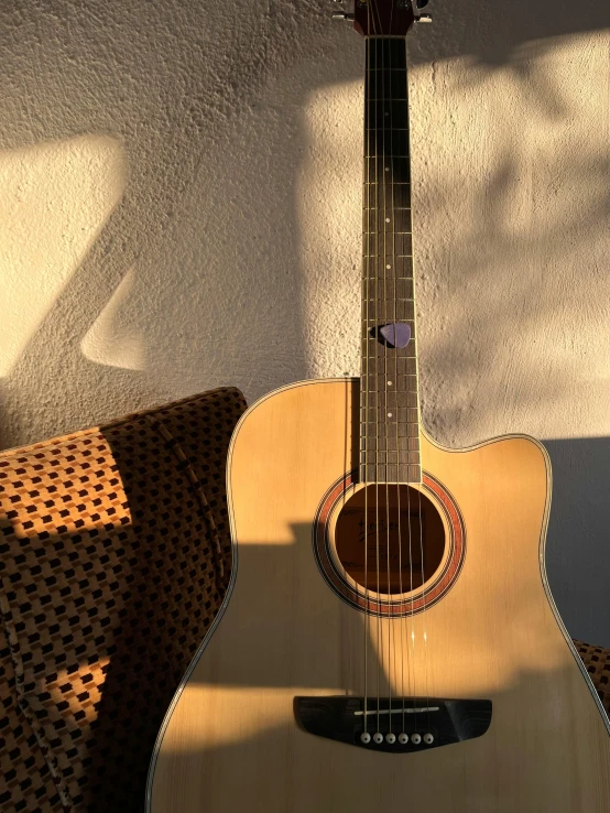 the guitar is in front of a chair